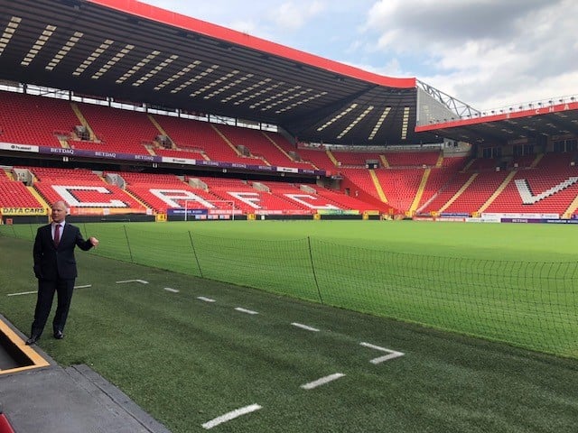 Richard Colwell struts his stuff by the Charlton Athletic dugout