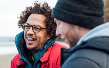 Warmly dressed men are talking on the beach